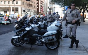 Arizona State Troopers line up outside the the Westin Phoenix downtown hotel in preparation to escort the Alabama Crimson Tide to their first practice at State Farm Stadium. (Photo by Spencer Barnes/Cronkite News)