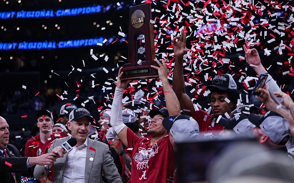 Mark Sears, named the West Region MVP, lifts the trophy high after leading Alabama to its first-ever Final Four appearance. (Photo by Bennett Silvyn/Cronkite News)