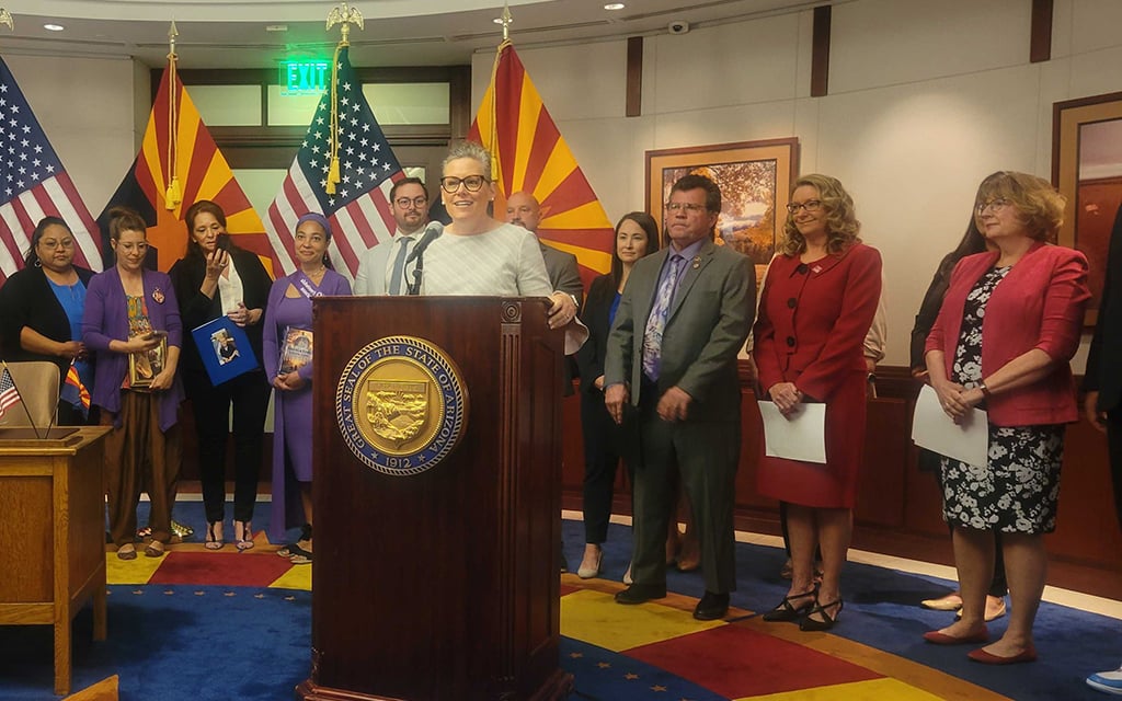 Gov. Katie Hobbs, backed by supporters of HB 2764, signs the bill into law on April 8, 2024, in the Arizona State Capitol Executive Tower in Phoenix. (Photo by Analisa Valdez/Cronkite News)