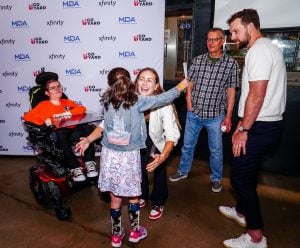 Jayme (middle) and Rhys Hoskins (right) share a moment with young campers at the second annual “Go Yard with Rhys Hoskins” fundraiser for muscular dystrophy awareness on June 29, 2023. (Photo courtesy of Philadelphia Phillies)