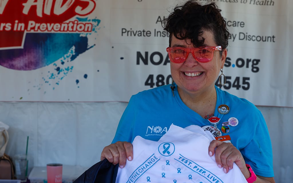 Andrea Leuser, an HIV nurse navigator at Neighborhood Outreach Access to Health (NOAH) poses for a photo at the Aunt Rita’s Paint the Town Red AIDS Walk Arizona & 5K Run on Saturday, April 6, at Tempe Beach Park. (Photo by Kayla Mae Jackson/Cronkite News)