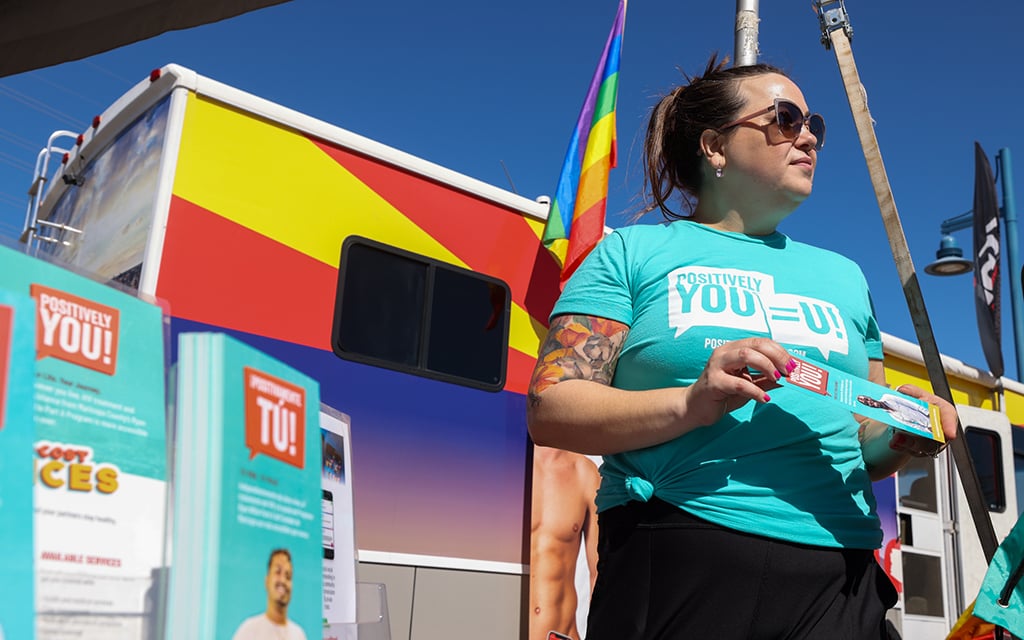 Kate Thomas, senior health educator for the Ending the HIV Epidemic plan at Maricopa County Public Health, talks with event attendees at the Aunt Rita’s Paint the Town Red AIDS Walk Arizona & 5K Run held on April 6 at Tempe Beach Park. (Photo by Kayla Mae Jackson/Cronkite News)

