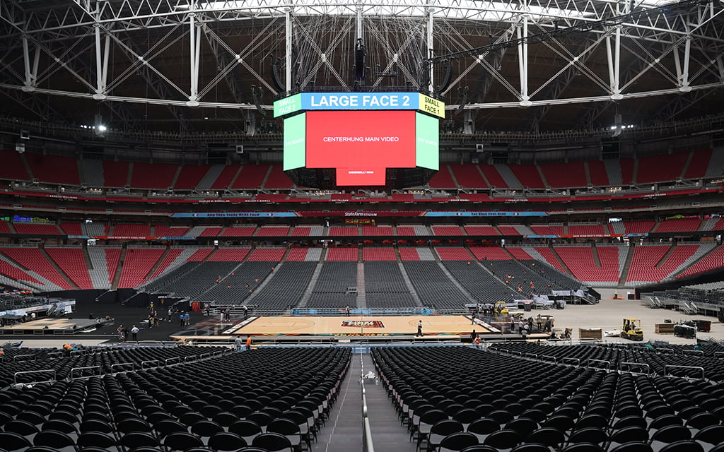 One challenge associated with constructing a basketball court in a football stadium is that it becomes necessary to build a stage for the court to sit on. (Photo by Joe Eigo/Cronkite News)