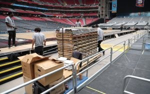 The court for the Men’s Final Four is 70 feet by 140 feet, with panels weighing approximately 165 pounds each and 58,000 pounds in total. The assembly took an estimated four hours to complete. (Photo by Joe Eigo/Cronkite News)