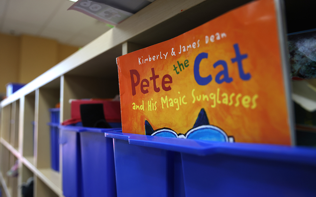 A children’s book peeks out of a cubby at Imagination Childcare and Preschool in Litchfield on April 2. (Photo by Kevinjonah Paguio/Cronkite News)