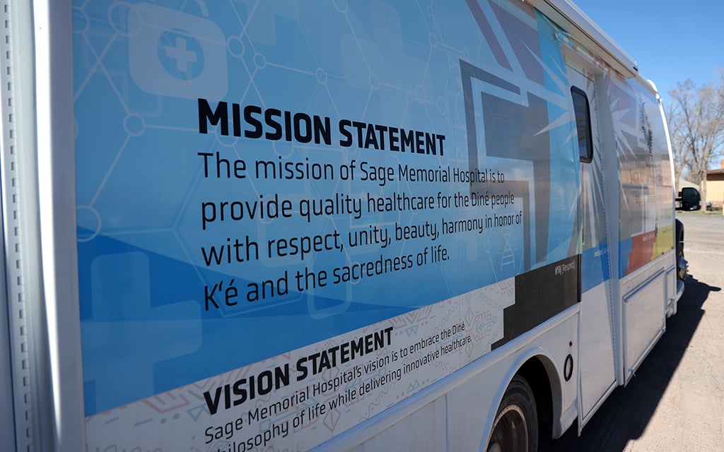 One of Sage Memorial’s mobile health care units displays its mission statement. “We’re hoping to provide comprehensive health care services,” said Kathryn Barron, nurse practitioner and director of outpatient services and community health at Sage Memorial. (Photo by Kevinjonah Paguio/Cronkite News)