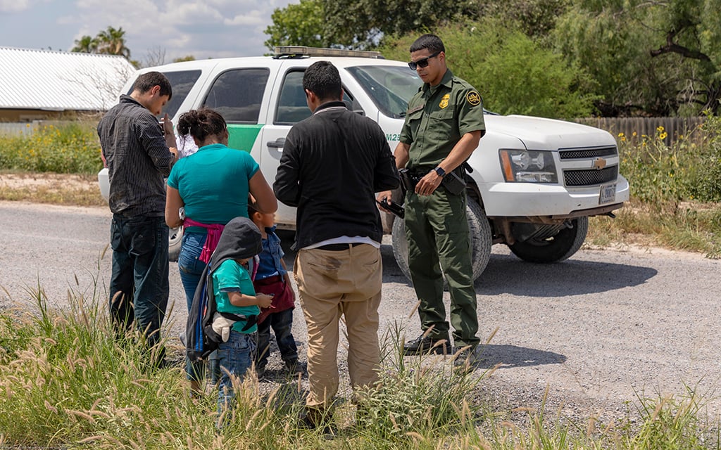 U.S. Border Patrol agents apprehends three adults and three children after they crossed the Rio Grande in a raft and surrendered. (Photo by Mani Albrecht/CBP)