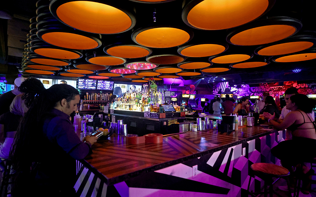 A vibrant bar scene surrounds classic arcade games and a blend of nightlife and nostalgia at Cobra Arcade Bar in Phoenix on June 26, 2024. (Photo by Stella Subasic/Cronkite News)