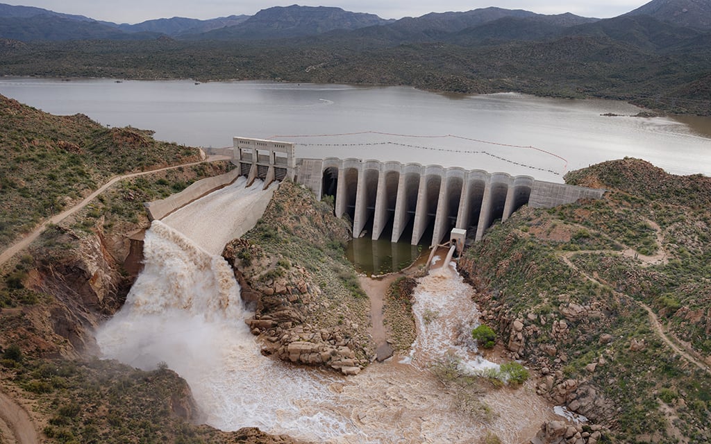 Water is released from behind Bartlett Dam in March 2023 after a wet winter. Cities that use water stored behind the dam want to fund a $1 billion expansion of the dam to make sure that extra water can be stored instead of released downstream. (Photo courtesy of Michael McNamara/Salt River Project)