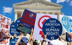 Abortion rights and anti-abortion protesters hold up signs at the Supreme Court in Washington, D.C., on June 24, 2024. (Photo by Morgan Kubasko/Cronkite News)