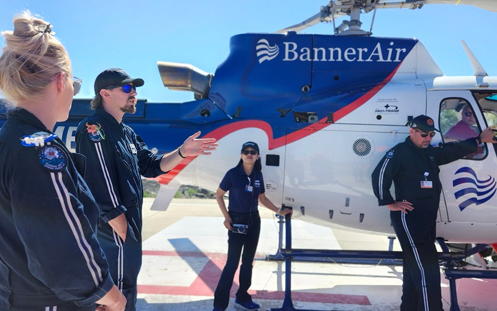 A BannerAir flight crew and staff are pictured in front of a medevac helicopter on the Banner Ironwood Medical Center helipad in Queen Creek. (Photo courtesy of BannerAir)