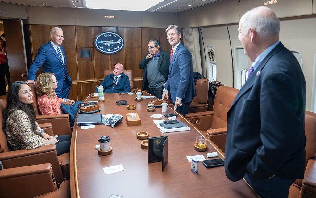 President Joe Biden meets with Mark Kelly, Raúl Grijalva and Greg Stanton aboard Air Force One in December 2022. (Photo by Adam Schultz/White House)