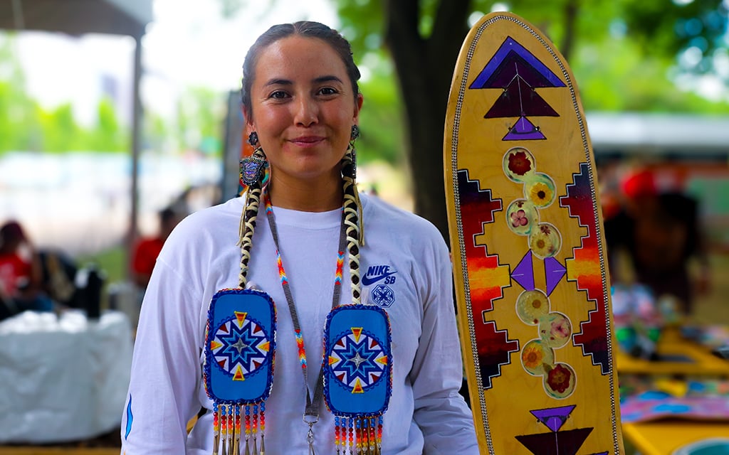 Di’Orr Greenwood with one of her handcrafted skateboards at the Smithsonian Folklife Festival in Washington, D.C., June 24, 2024. (Photo by Brianna Chappie/Cronkite News)
