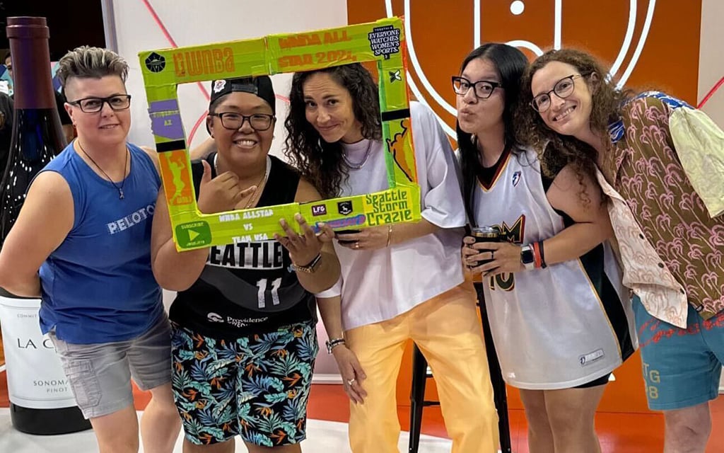Josie Dumlao, second from left, and Andrea Martinez, second from right, pose with Sue Bird, center, at WNBA Live, highlighting the league's commitment to LGBTQIA+ inclusion. (Photo courtesy of Andrea Martinez)