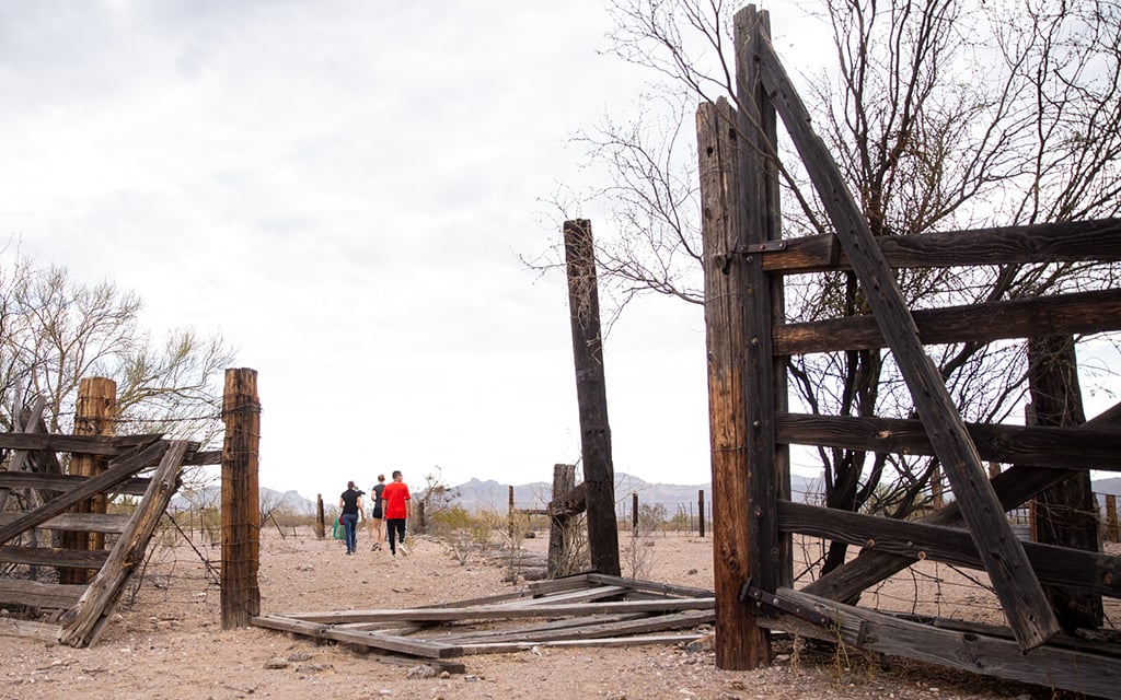 Volunteers for No More Deaths walk through an abandoned corral, one of many sites where the organization leaves food and water for migrants crossing the desert in southern Arizona. (File photo by Ellen O’Brien/Cronkite News)