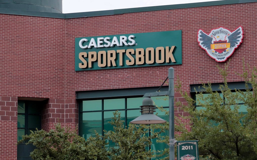 The Caesars Sportsbook sign at Guy Fieri's DTPHX Kitchen + Bar represents a new normal in Arizona, where legalized sports betting is a daily activity for fans, including ASU students. (Photo by Grace Hand/Cronkite News)