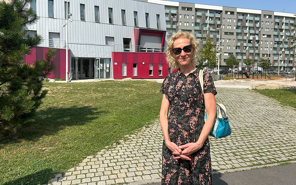 Severine Theiffrey, founder of Féte le Mur, poses in front of the Féte le Mur building in the La Courneuve neighborhood of Paris. (Photo by Zach Bradshaw/Special for Cronkite News)