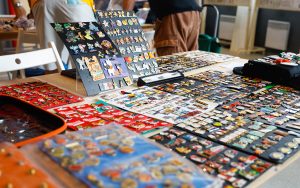 Olympic and Disney pins are displayed for trading at the Official Olympic Collectors Area Paris 2024 near Club France in Parc de la Villette. (Photo by Sydney Lovan/Special for Cronkite News)