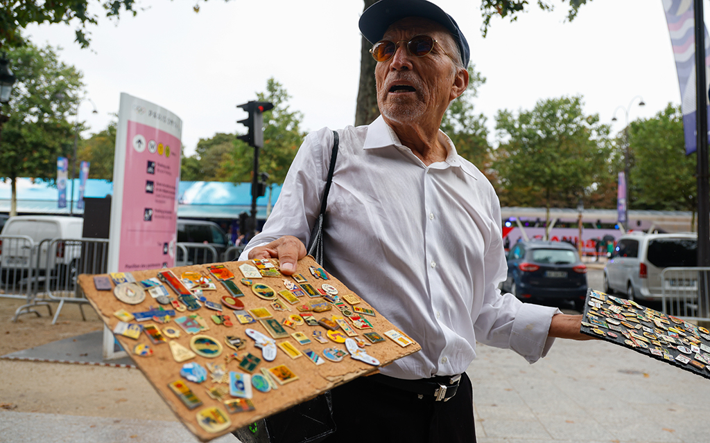 An Olympics pin collector displays the pins he was trading on the streets of Paris. (Photo by Sydney Lovan/Special for Cronkite News)