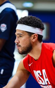 All-Star guard and nine-year Phoenix Sun, Devin Booker, stretches before practice at the Marcel Cerdan Sports Complex in Paris, France. (Photo by Spencer Barnes/Special for Cronkite News)