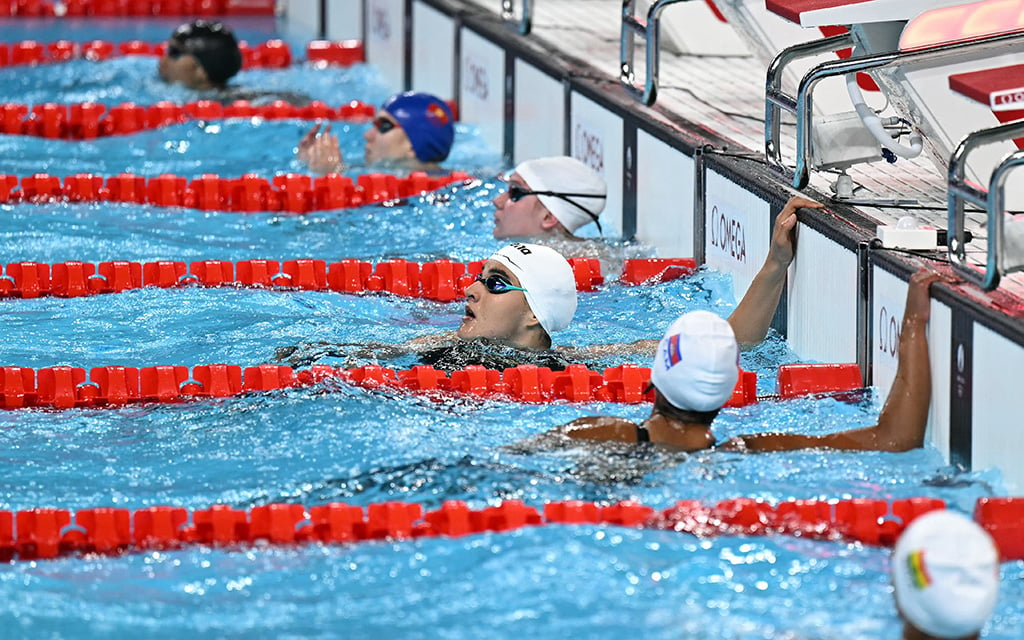 Mariam Sheikhalizadehkhanghah, center, reacts after competing in a heat of the women's 50-meter freestyle swimming event during the Paris Games. Sheikhalizadehkhanghah is excited to return to the University of Arizona and compete in the Big 12. (Photo by Jonathan Nackstrand/AFP via Getty Images)