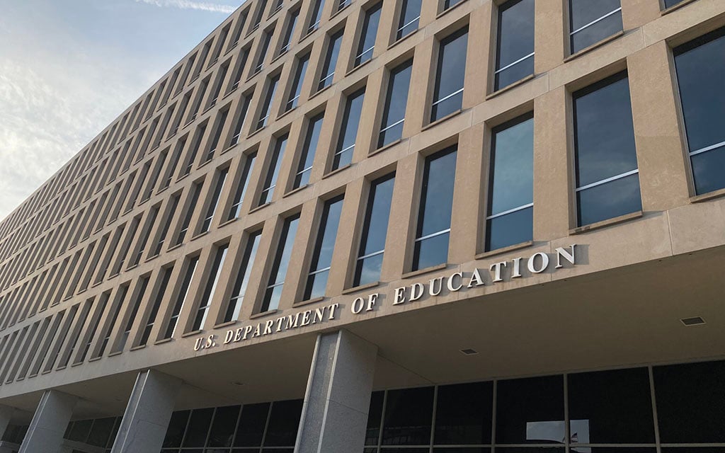 Facade of the U.S. Department of Education building with rectangular windows and metal lettering of the agency's name.