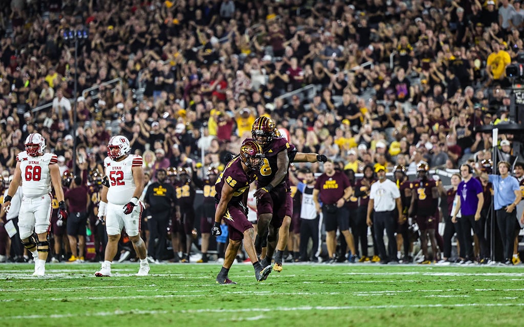 ASU linebacker Caleb McCullough celebrates a tackle for loss against Utah with a teammate