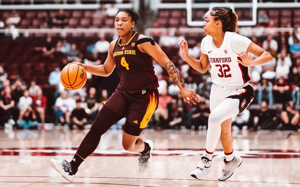 Arizona State's Trayanna Crisp dribbles against a player wearing a Stanford jersey during a game.