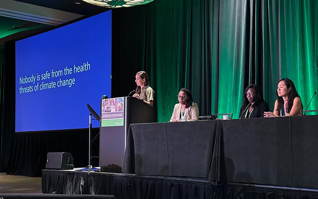 Dr. Leticia M. Nogueira speaking in front of other panelists at the 17th annual AACR Conference.