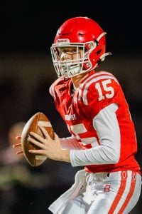 Case Vanden Bosch, in a red uniform with the number 15, holding a football.