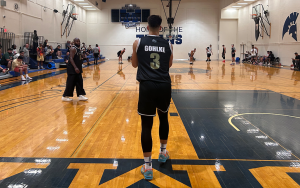 Jack Gohlke wearing a black basketball uniform inbounds a basketball to a teammate