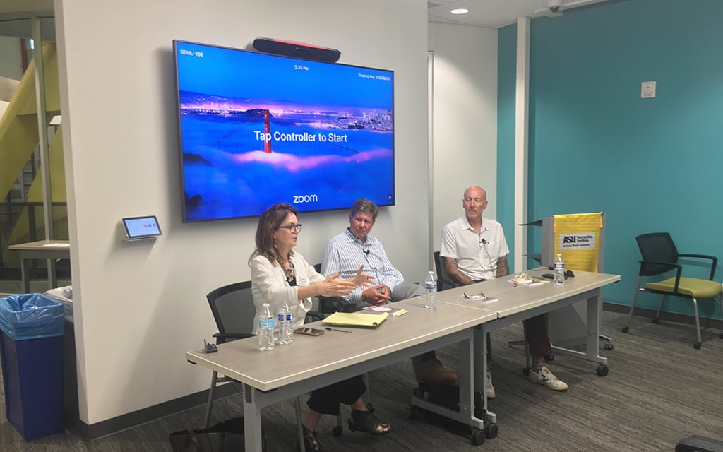 Tracy Fessenden, Randall Balmer, and Terry Shoemaker seated at a table with a digital screen in the background discussing sports and religion