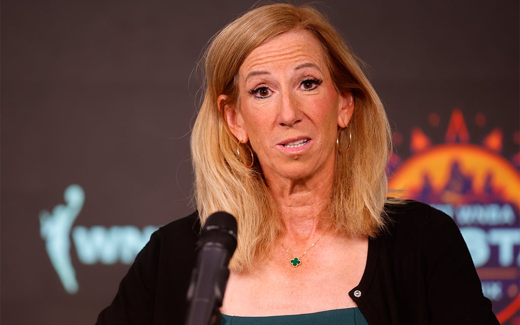 WNBA commissioner Cathy Engelbert speaks at a press event with a microphone in front of her.