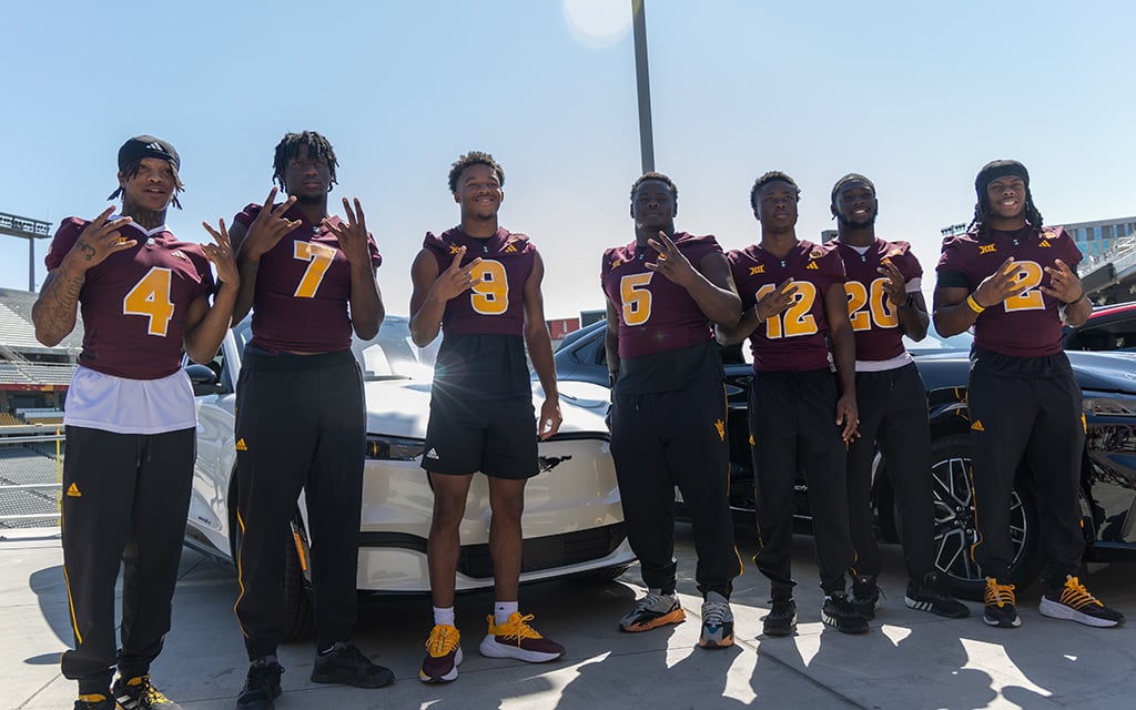 ASU football players Myles Rowser, Chamon Metayer, Montana Warren, Jeff Clark, Javan Robinson and Kyson Brown pose in front of their new cars.