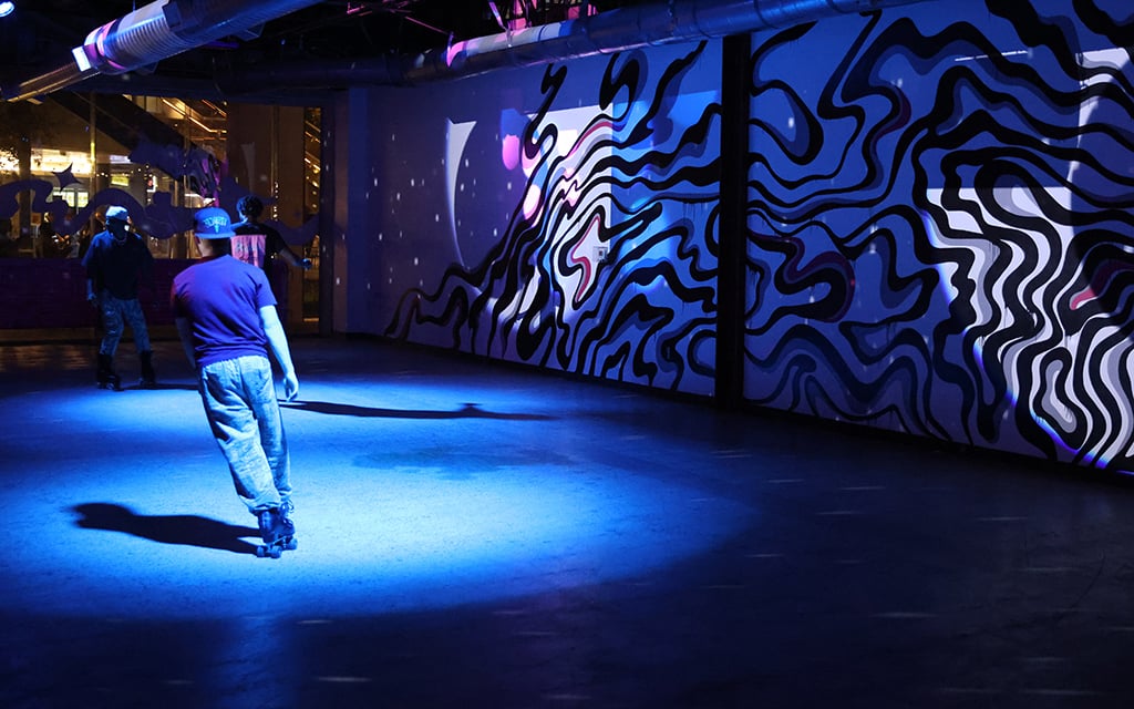 A skater makes a turn while skating during an event at the Zoni Girls roller venue on Nov. 16, 2024, at the Arizona Center in downtown Phoenix. (Photo by Aryton Temcio/Cronkite News)