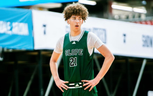 Basketball player wearing green Slope jersey with hands on hips.