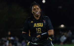 Sophia Smith, flag football player for ASU, wearing a black jersey with the number 18 at night.