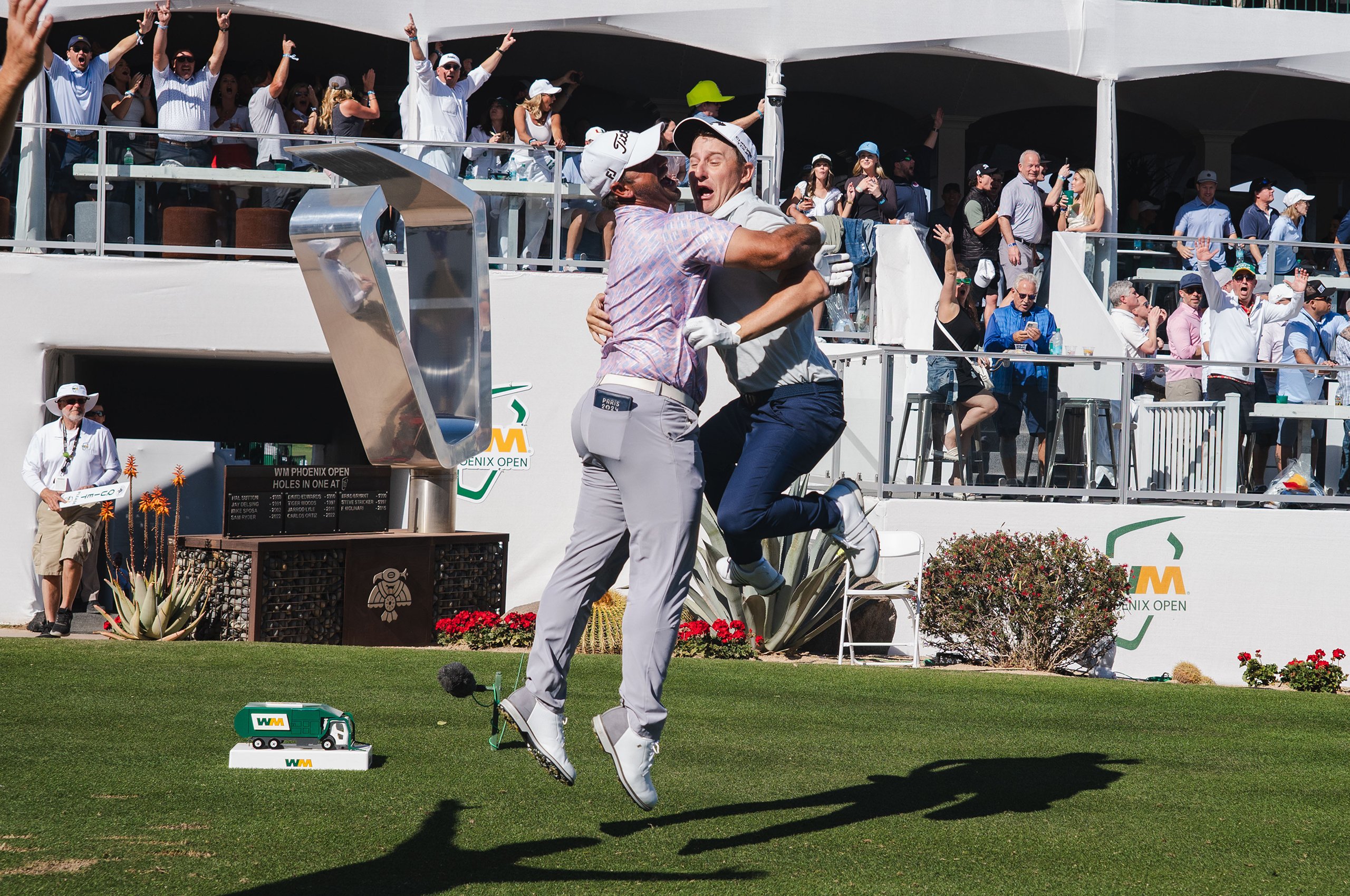 Emiliano Grillo jumps into the hug of play partner Rafael Campos after the Grillo Hole in one to hole 16 during the open phoenix in 2025, in Scotsdale, AZ, on Friday February 7, 2025. The hole in one was 12 hole In one of the hole 16 in the history of the tournament. (Photo by Samuel Nut/Kronkit News)